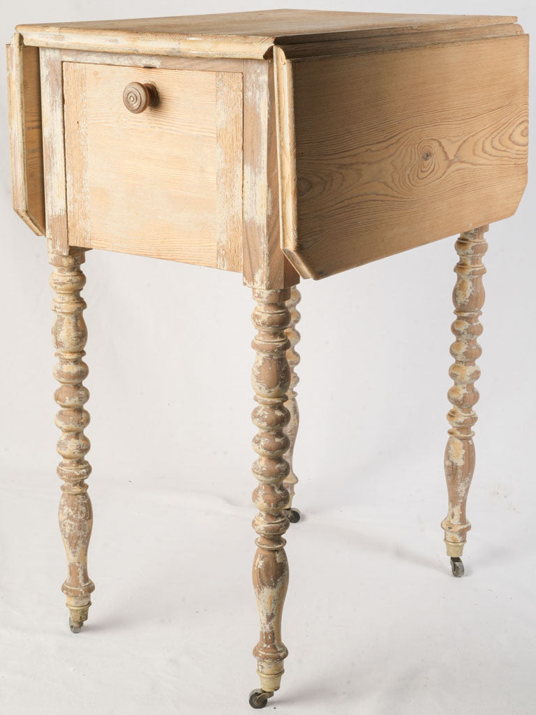 Compact antique bedside cabinet on casters