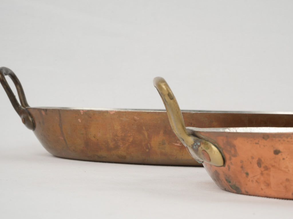 Aged brass-handled oval copper gratin pans