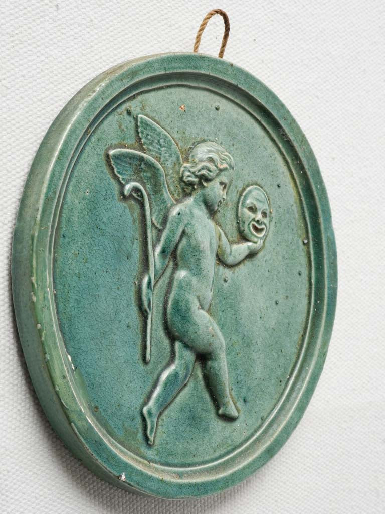 Elegant winged putto ceramic medallion