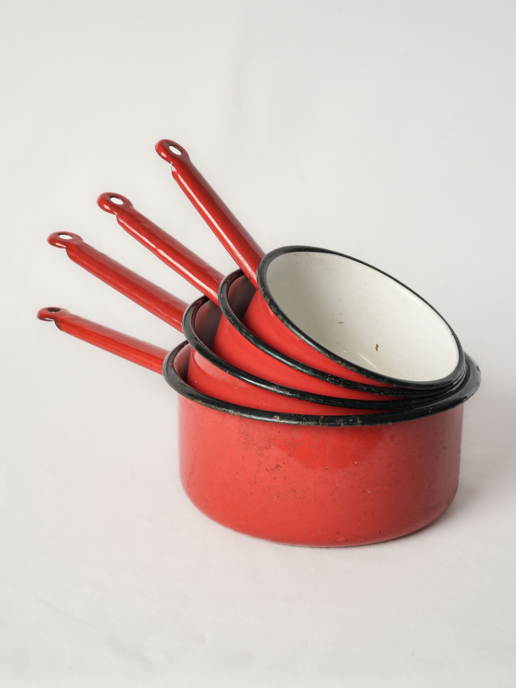 Set of Four Graduated Red Enamel Saucepans
