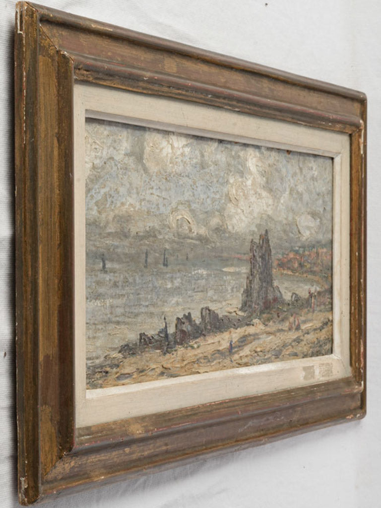Gilt-framed beach landscape artwork.