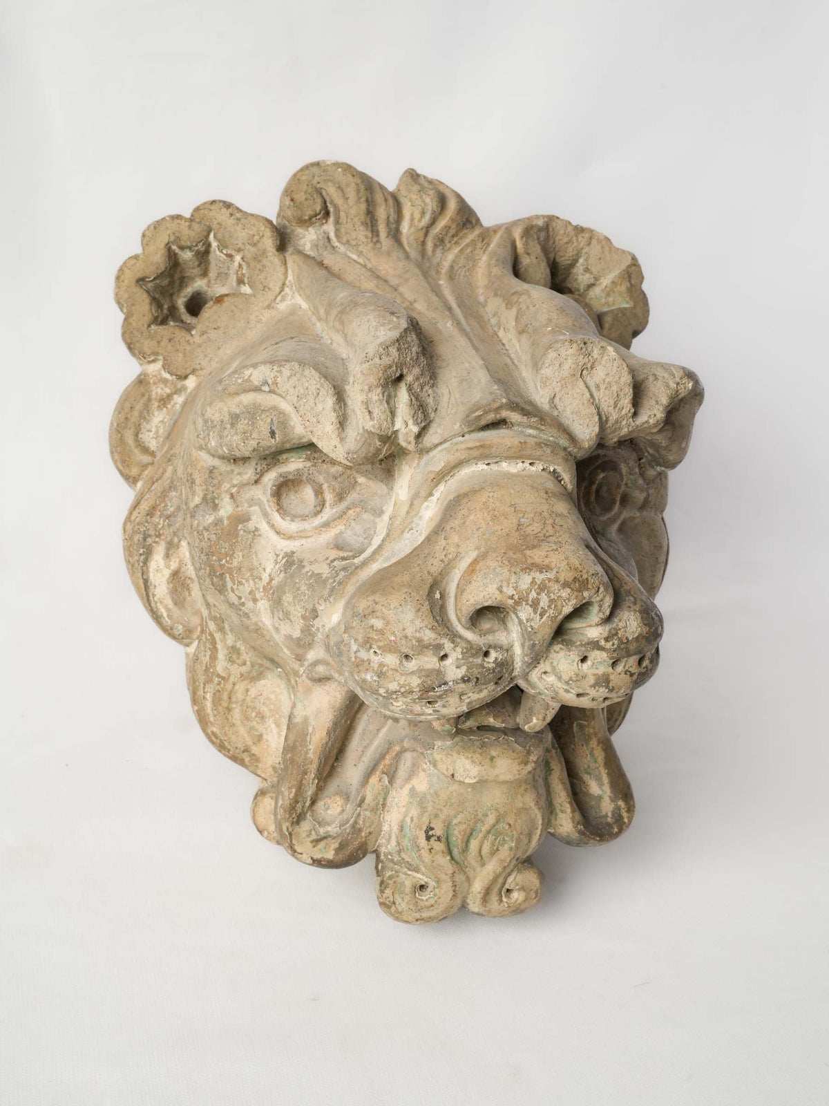 Weathered buff-toned lion-head fountain