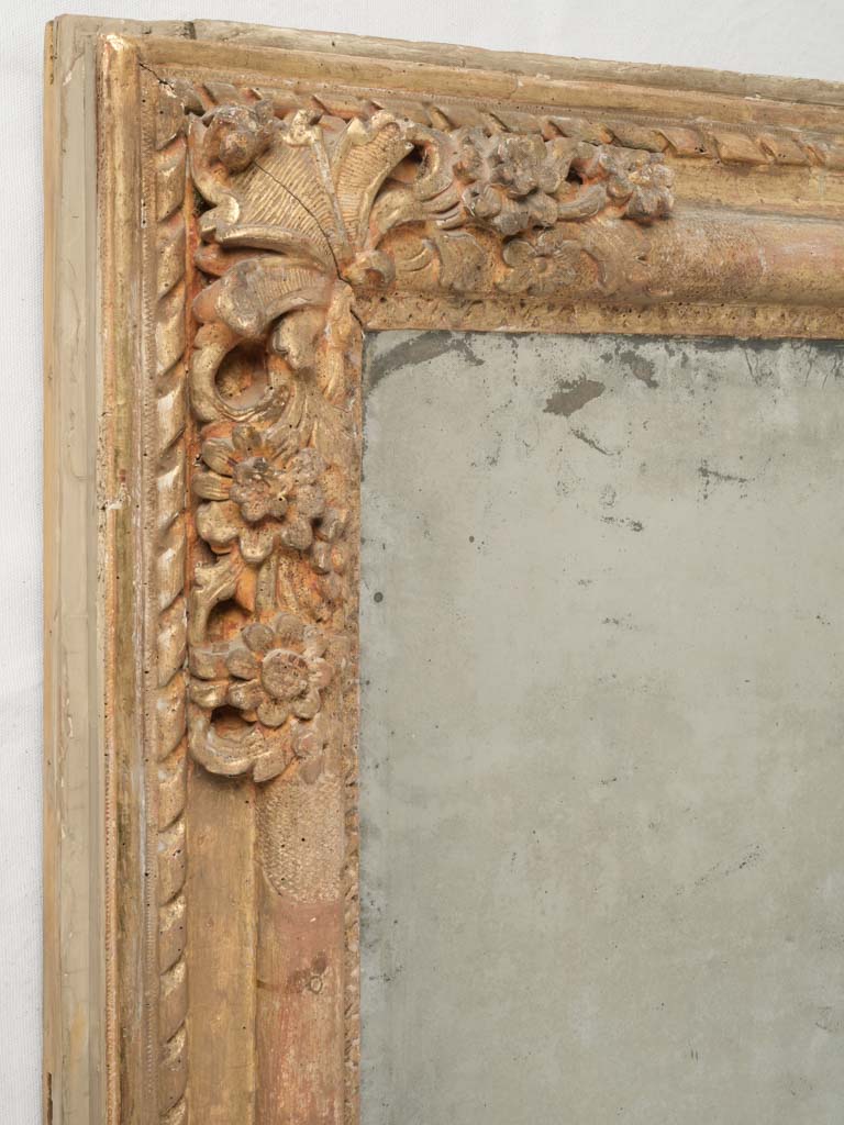 Patinated floral motif boiserie mirror