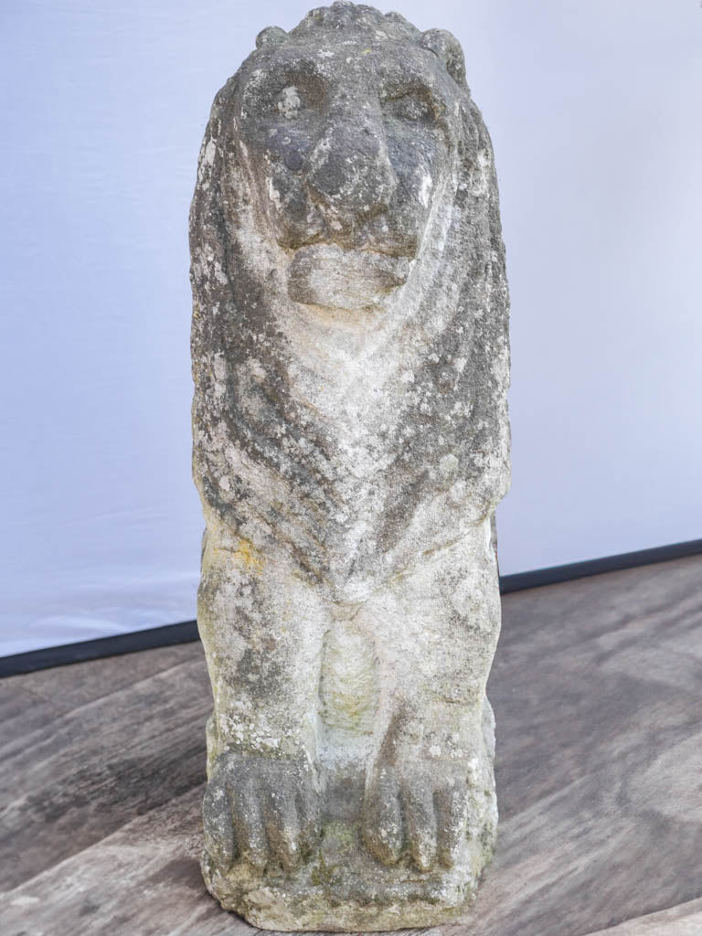 Aged stone sitting lion statues