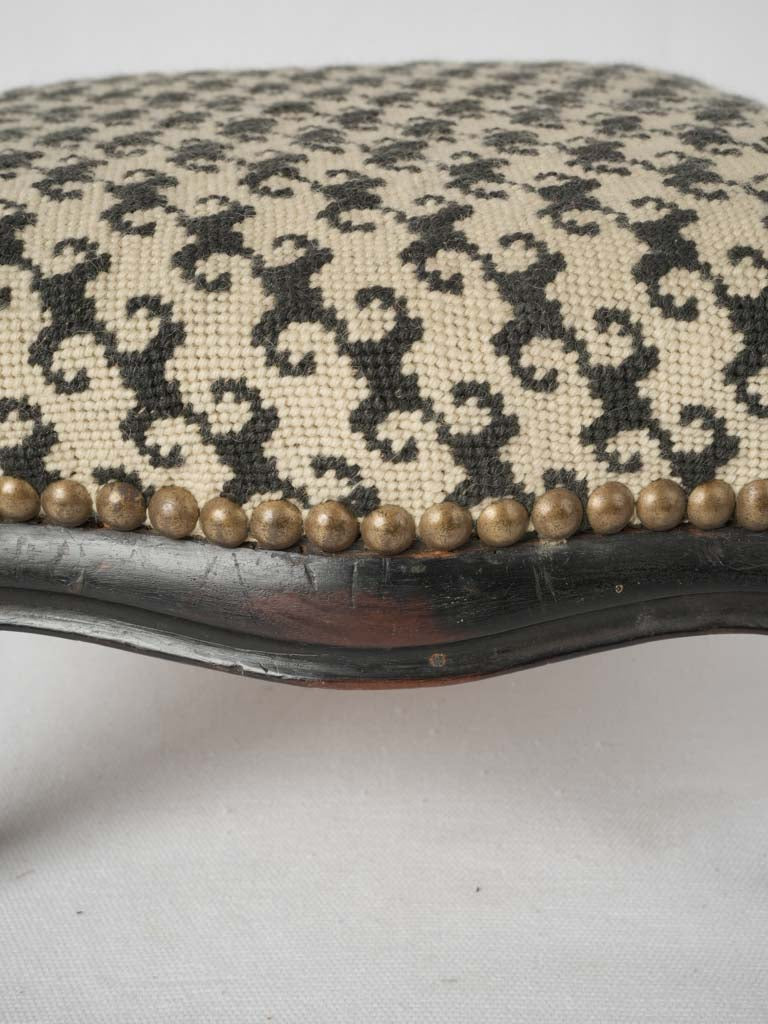 Hand-stitched upholstery on antique footrest
