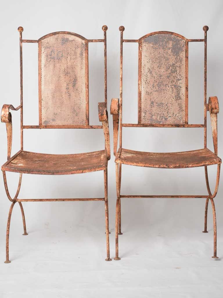 Pair of wrought iron garden armchairs