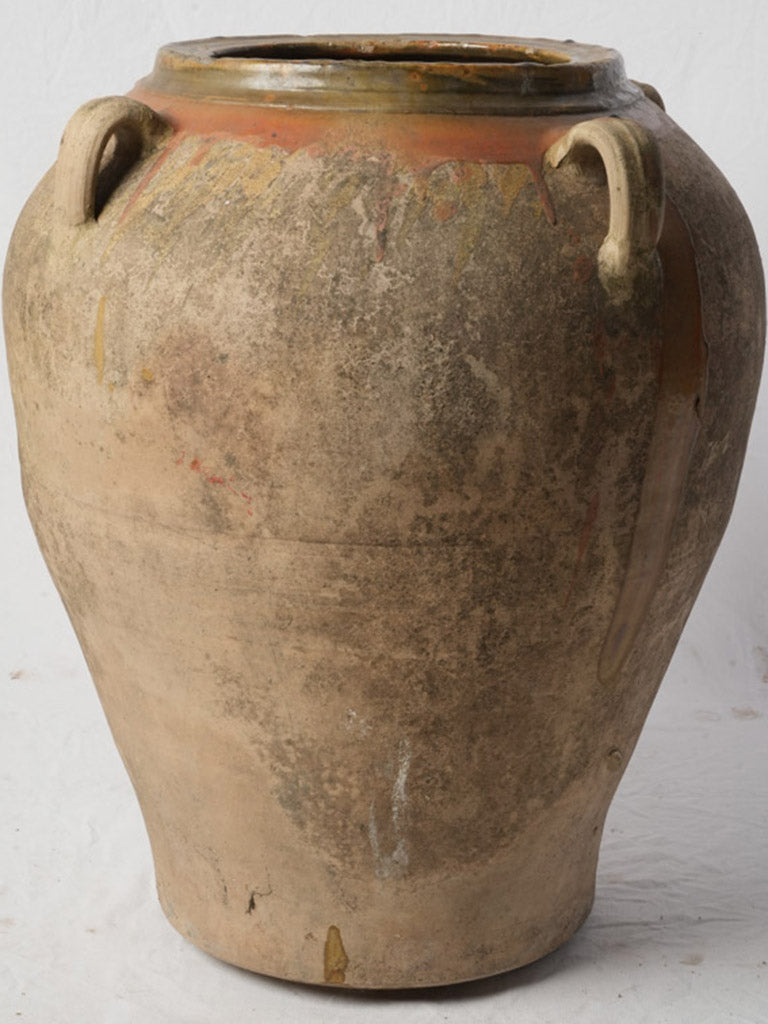 Weathered ochre-glazed pottery vessel