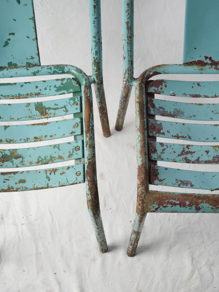 Weathered red-green patina Tolix chairs
