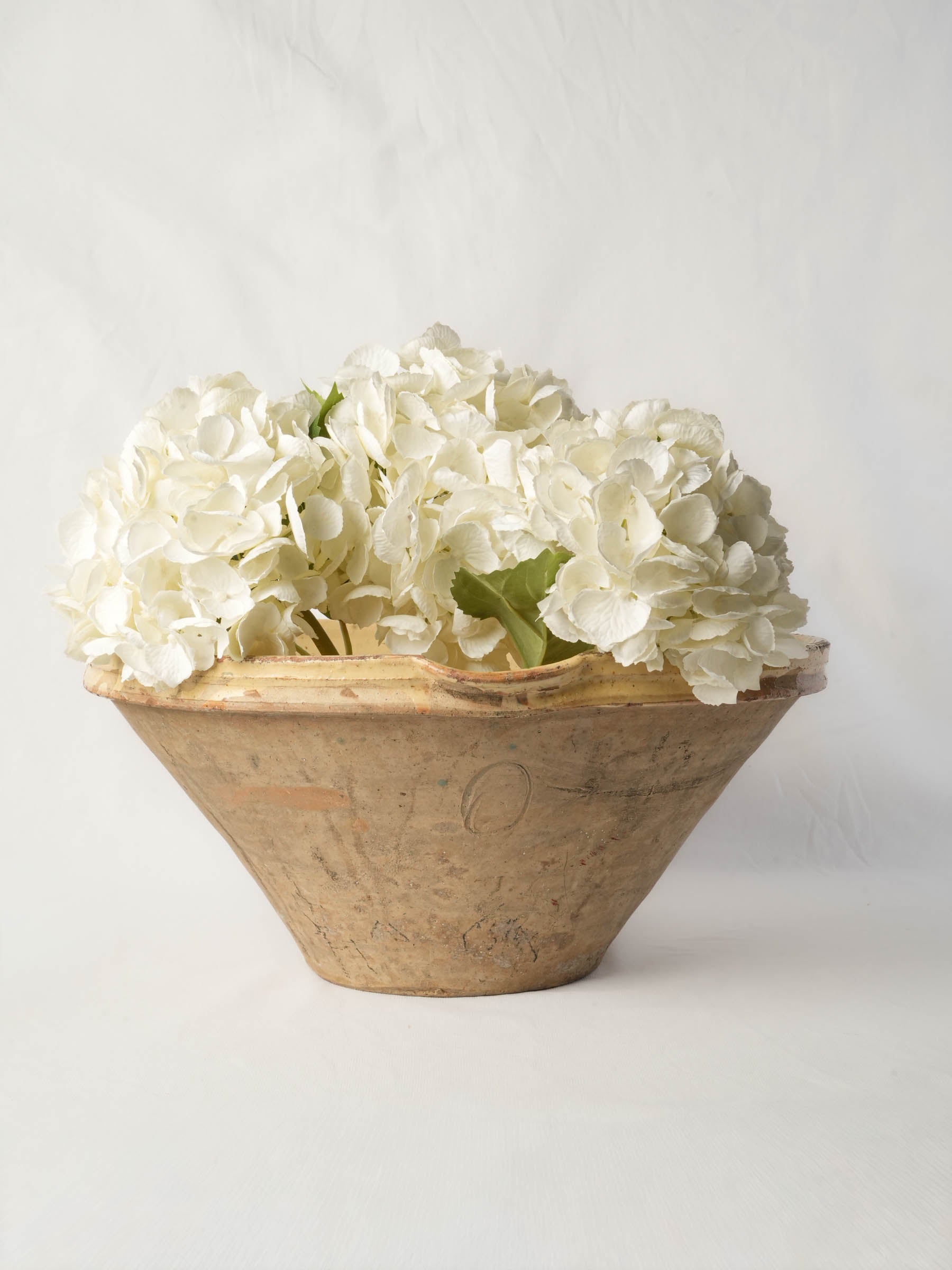 Large yellow-glazed conical kitchen bowl