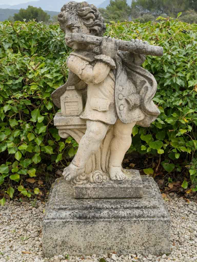 Timeless flute-playing cherub garden ornament