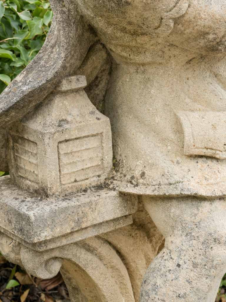 Aged stone cherub with flute garden sculpture