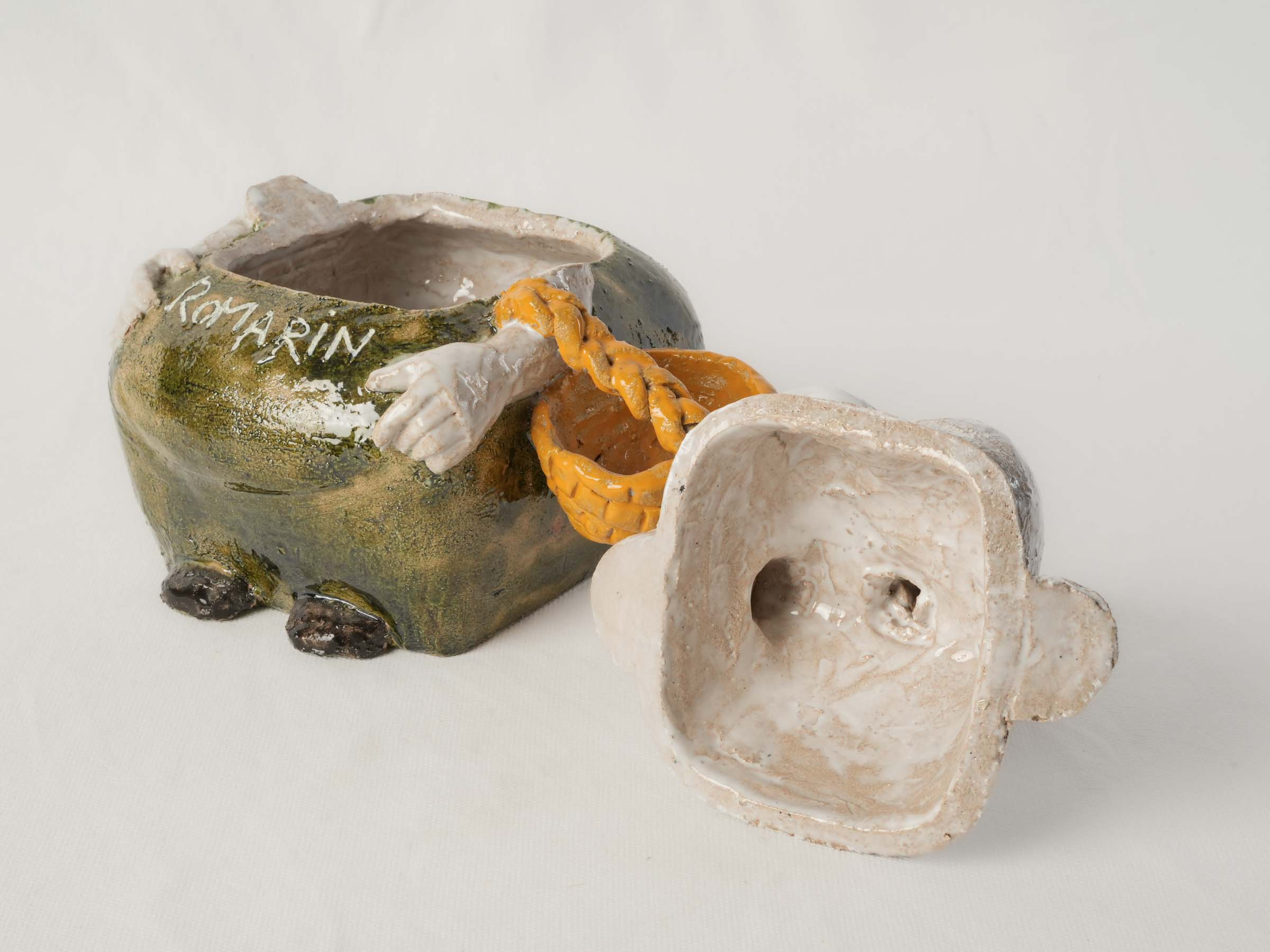 Artisan-crafted olive green container.