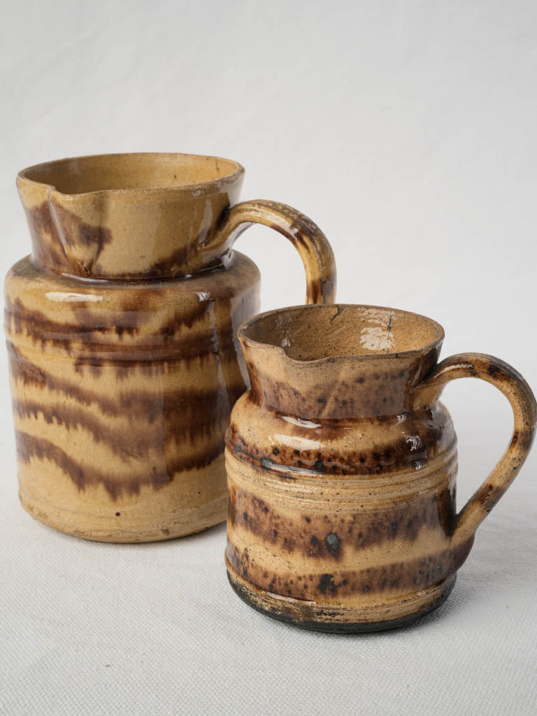 Rustic antique earthenware milk jugs