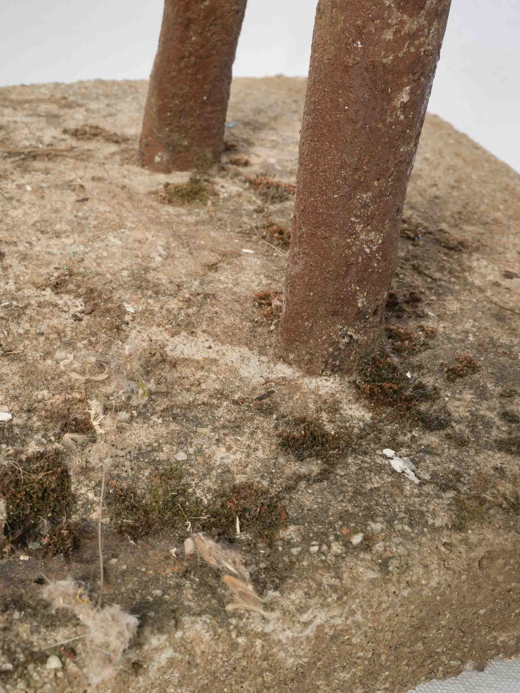 Folk-inspired painted concrete sculpture