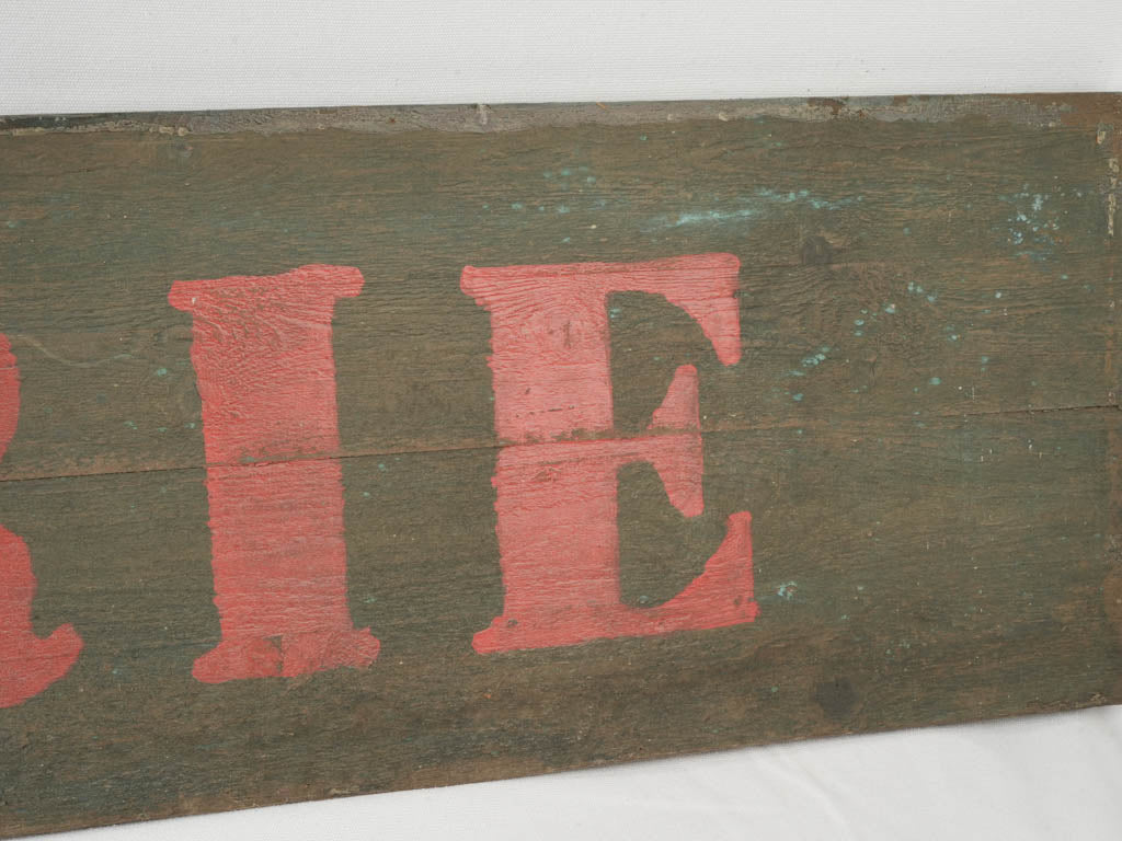 Weathered hand-painted wooden sign