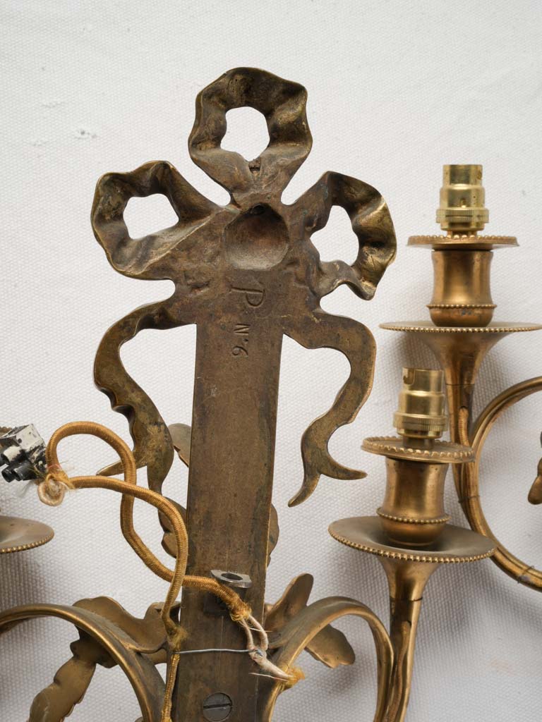 Decorative neoclassical ribbon sconces
