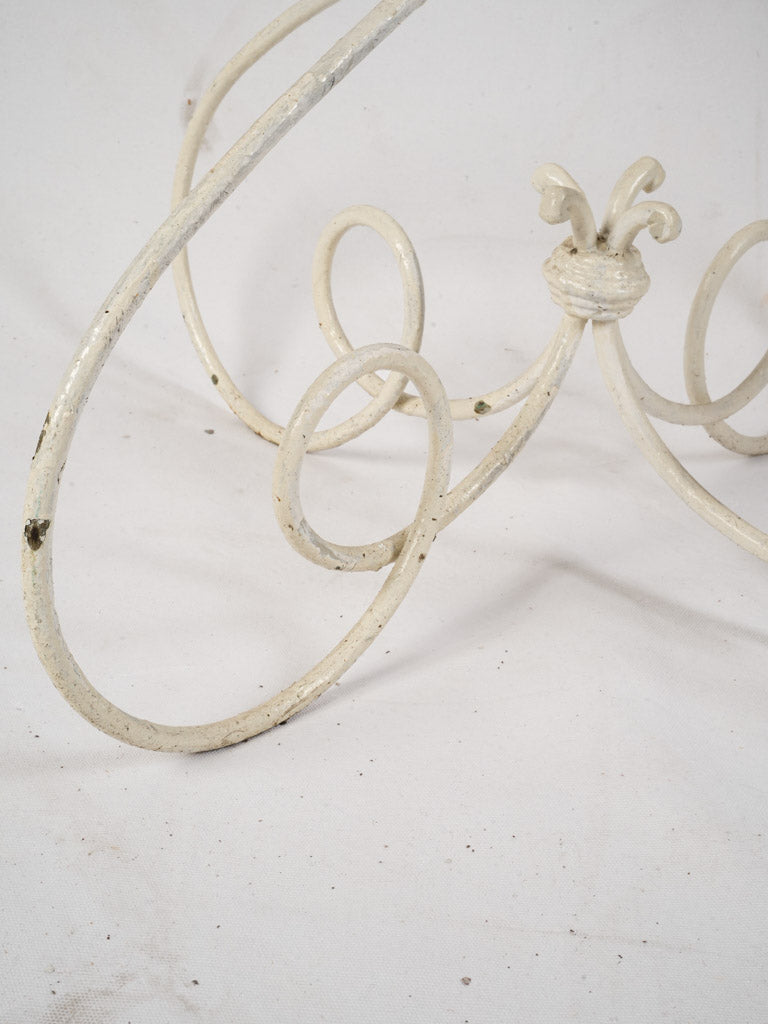 Graceful looping scrollwork stand  