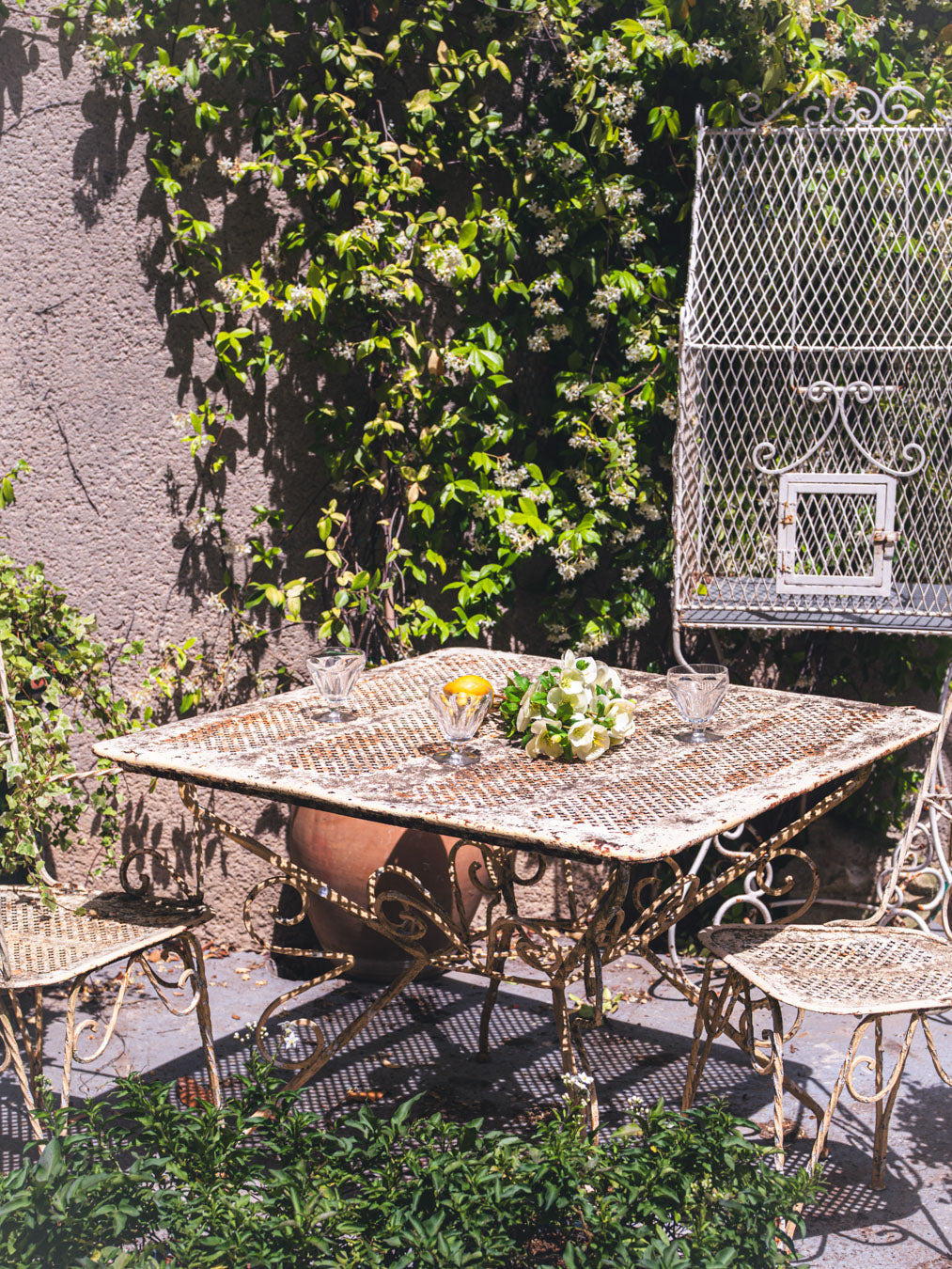 Rustic scrolled ironwork armchairs