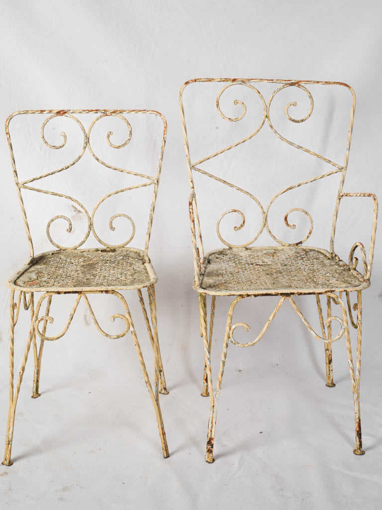 Distressed vintage wrought iron armchair