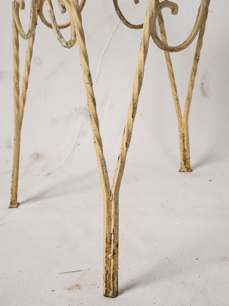Ornate scrolled ironwork patio chairs