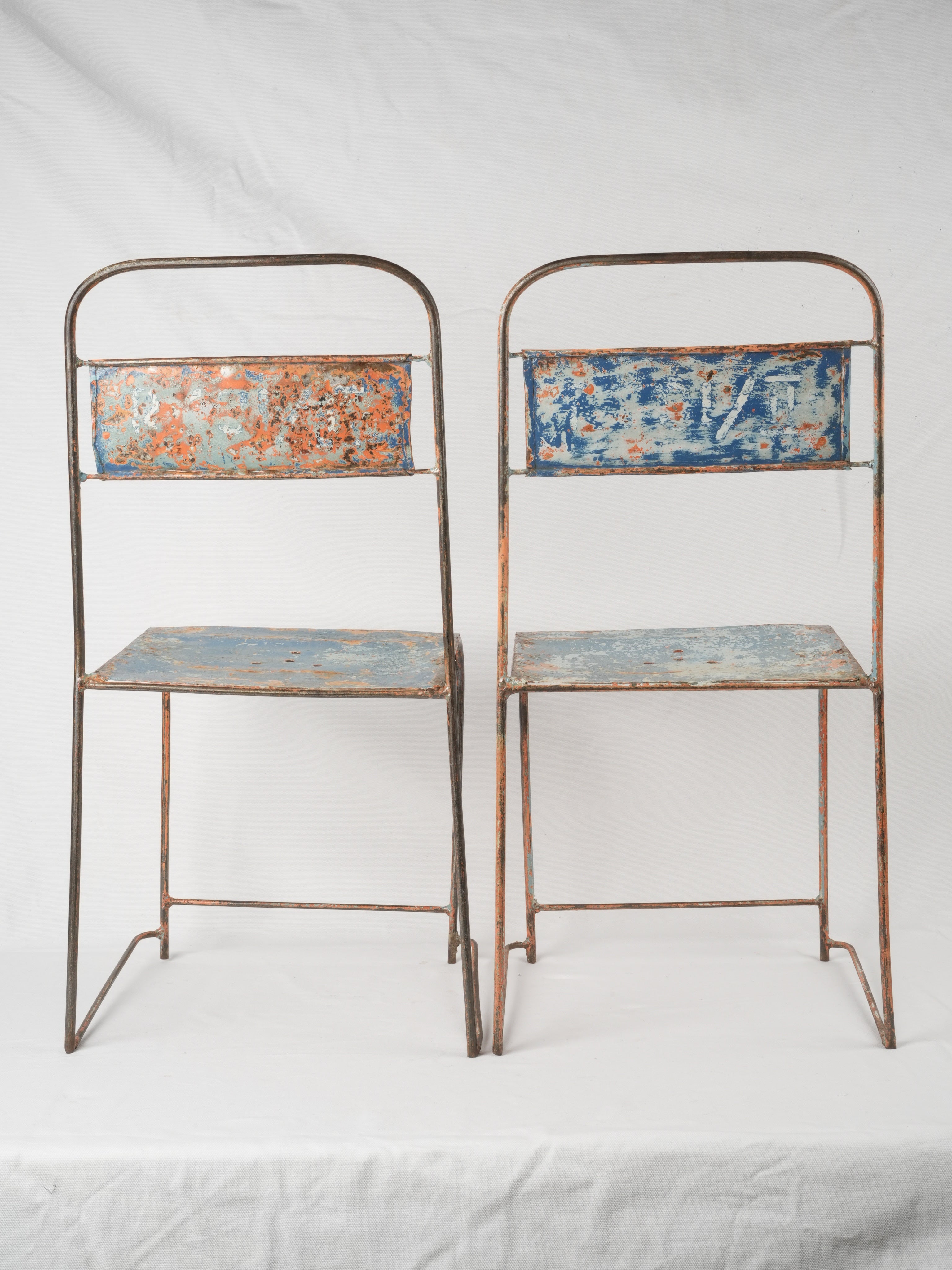 Patina-finished metal garden chairs