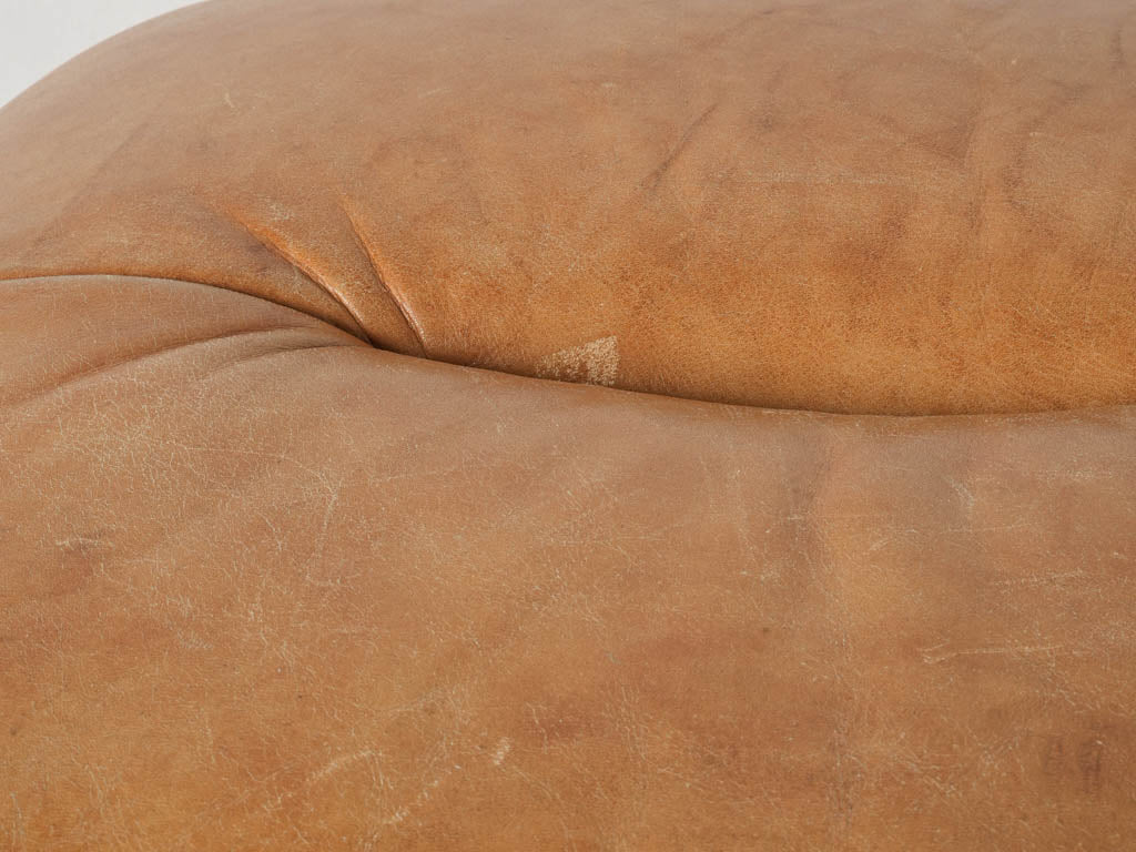 Inviting tan leather pouf