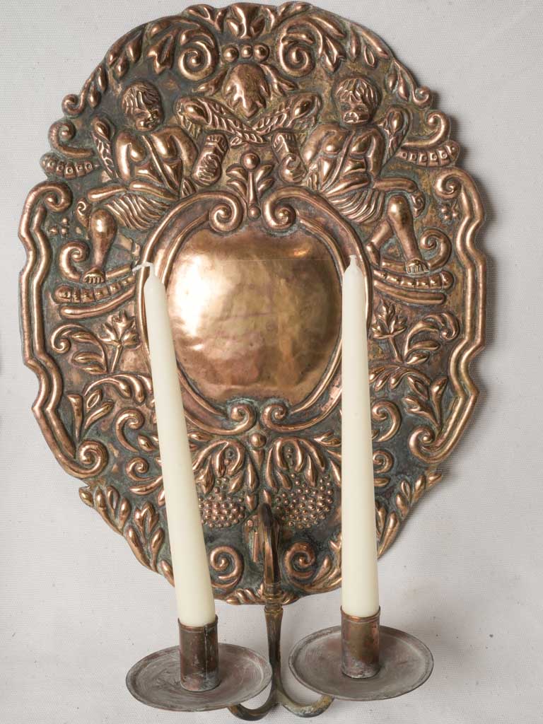 Oxidized opulent cherub-adorned sconces