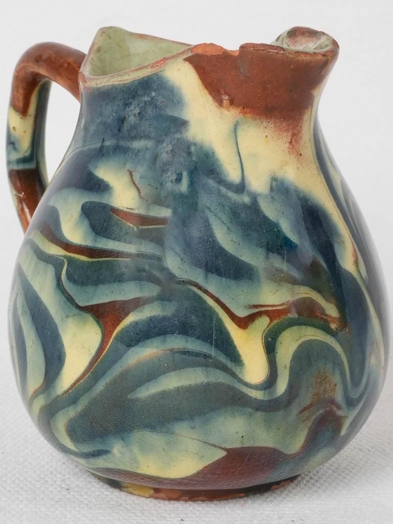 Aged blue and yellow ceramic jug