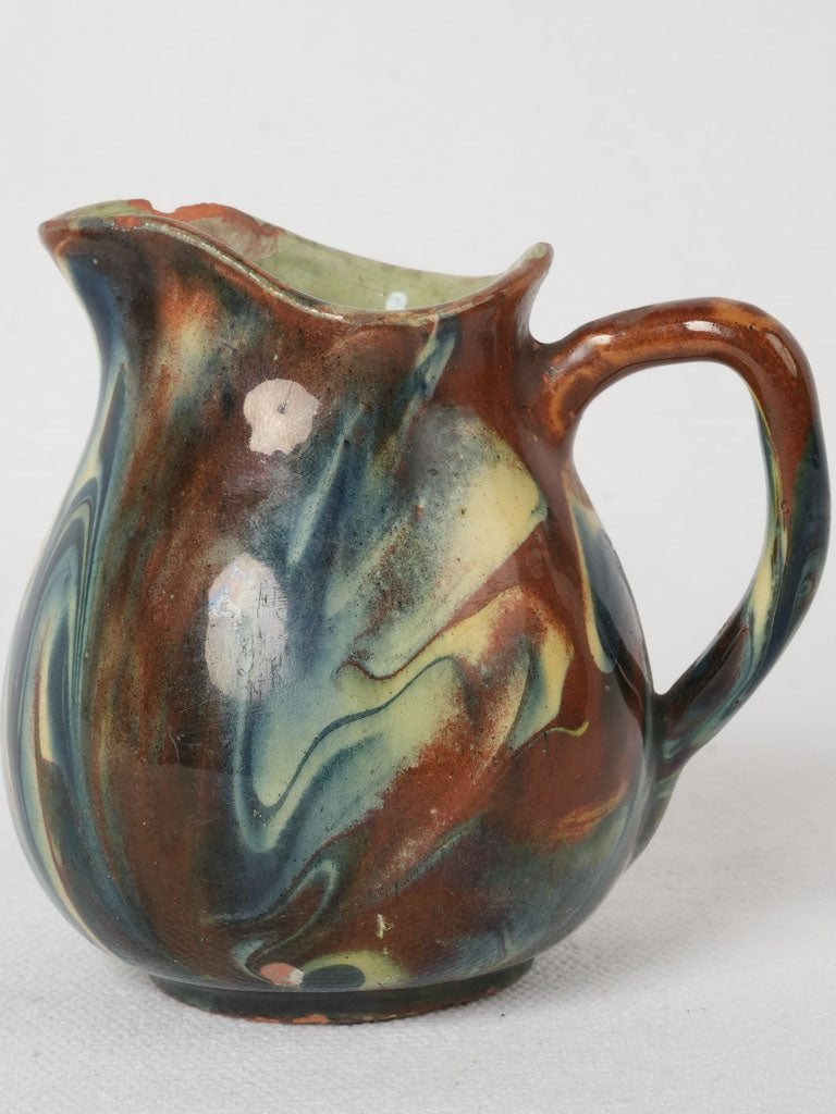 Swirled blue and brown pottery jug