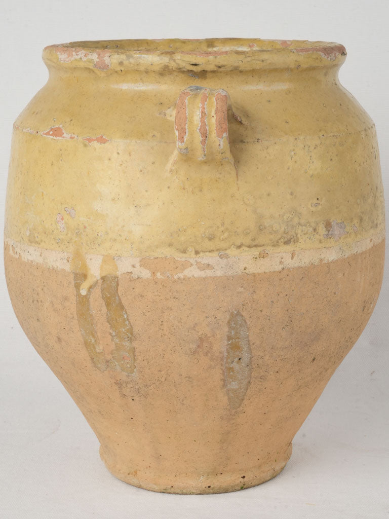 Aged ochre-yellow glazed pottery