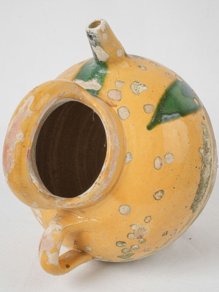Aged yellow and green water pitcher