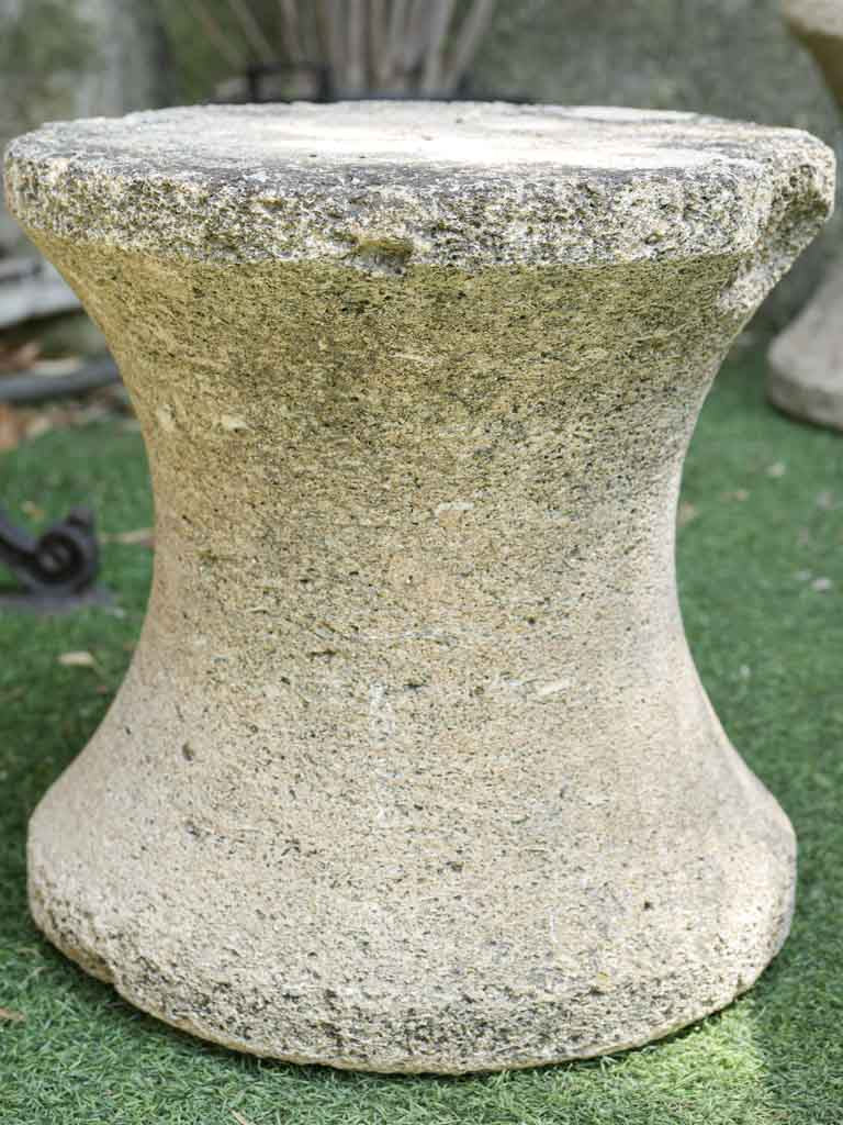 Aged hourglass limestone seat