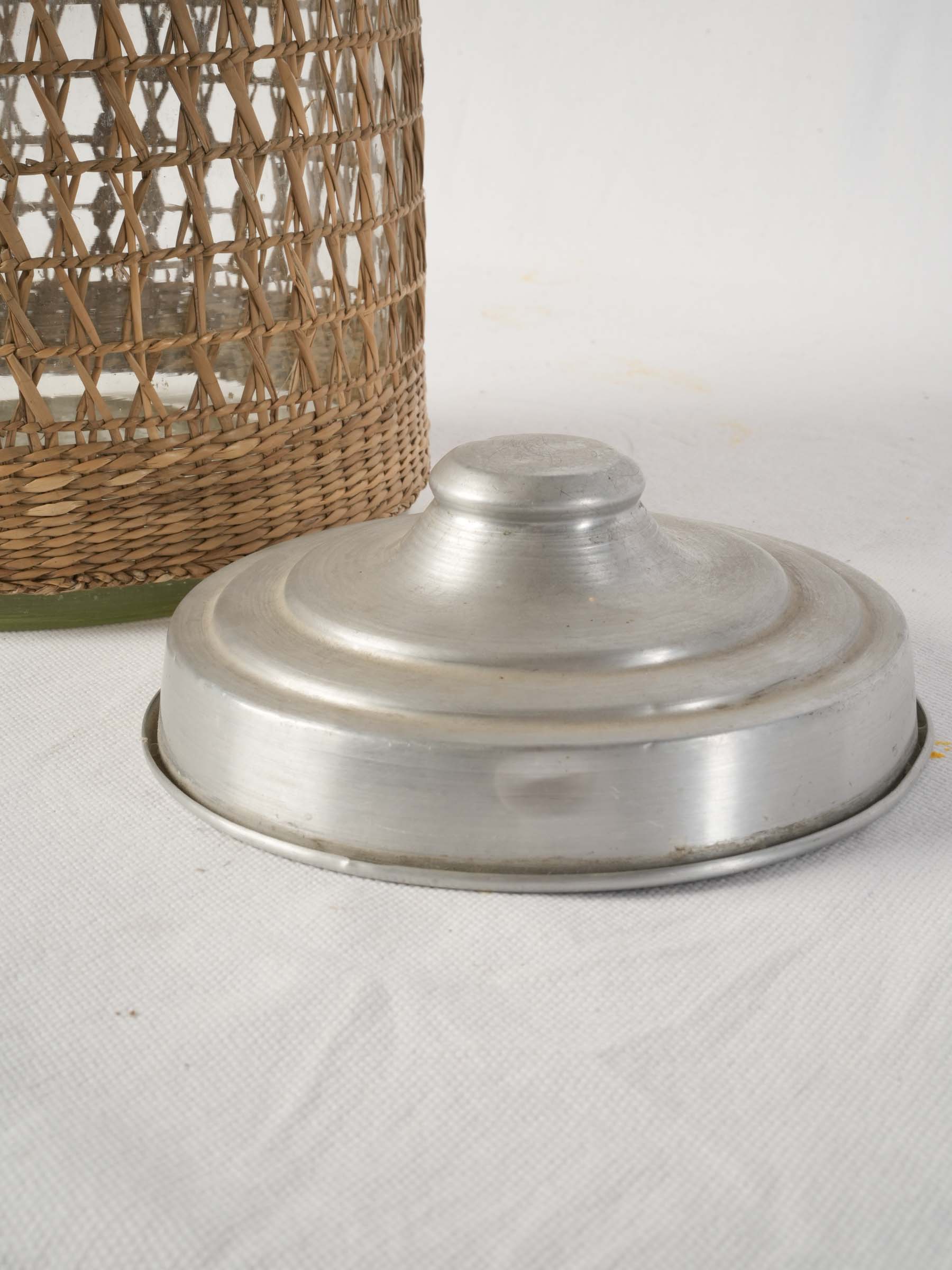 1960s rattan clad glass canister with aluminum lid - 15¾"
