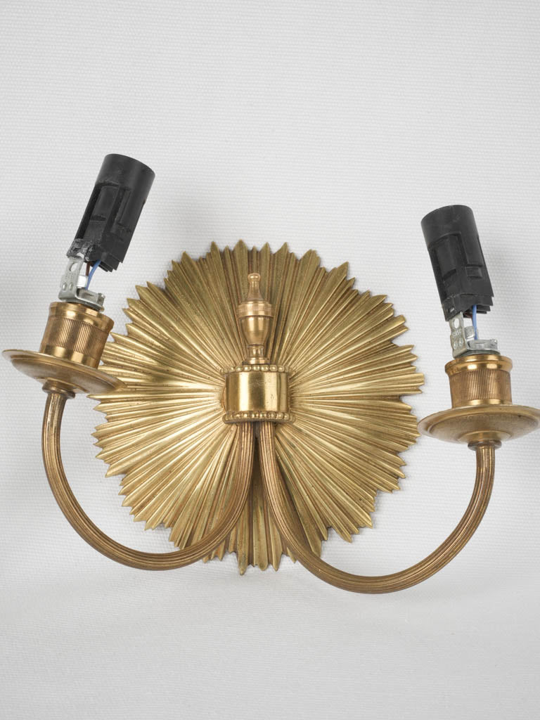 Ornate sunburst-shaped bronze sconces