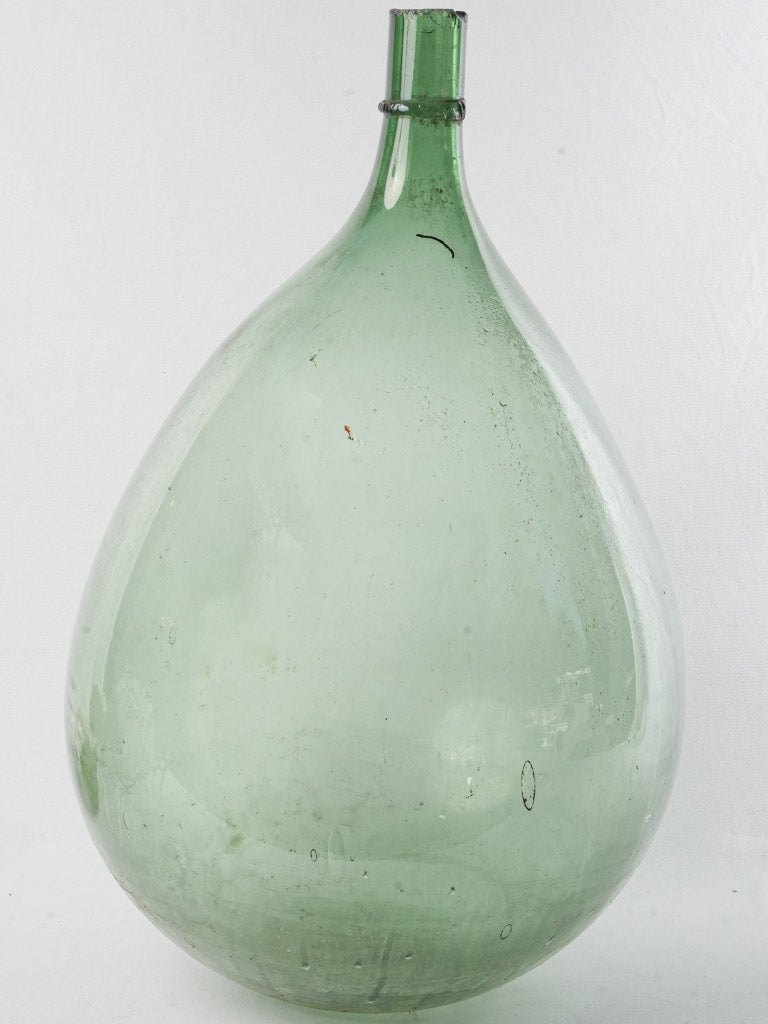 Elegant antique glass demijohn bottle