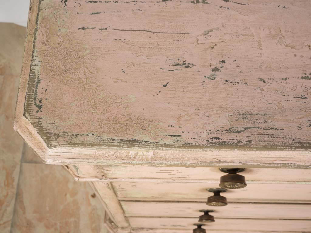 Warm powder-pink commode.