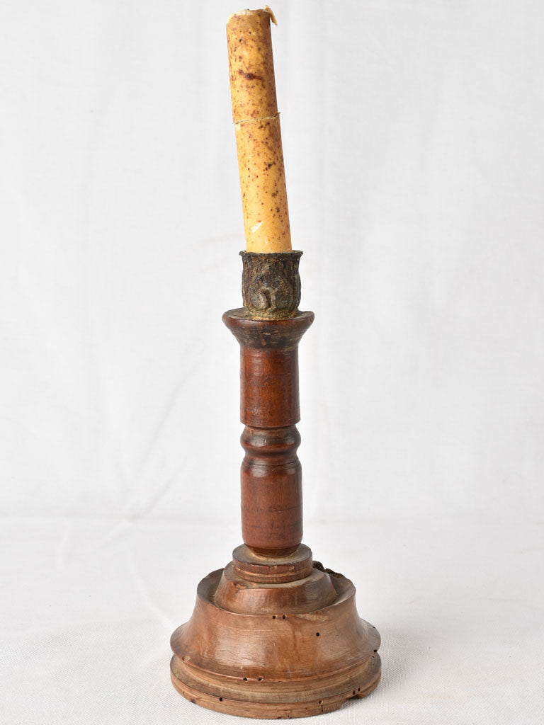 Worn-out bedside candle of metal
