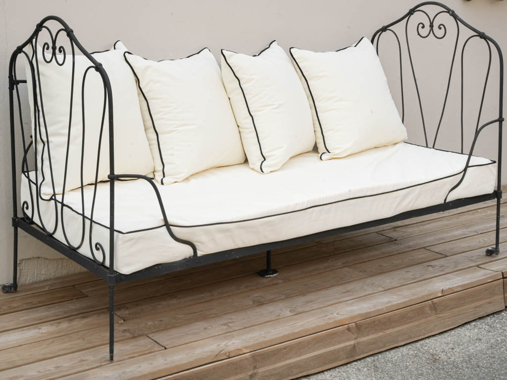 Graceful scrollwork iron banquette