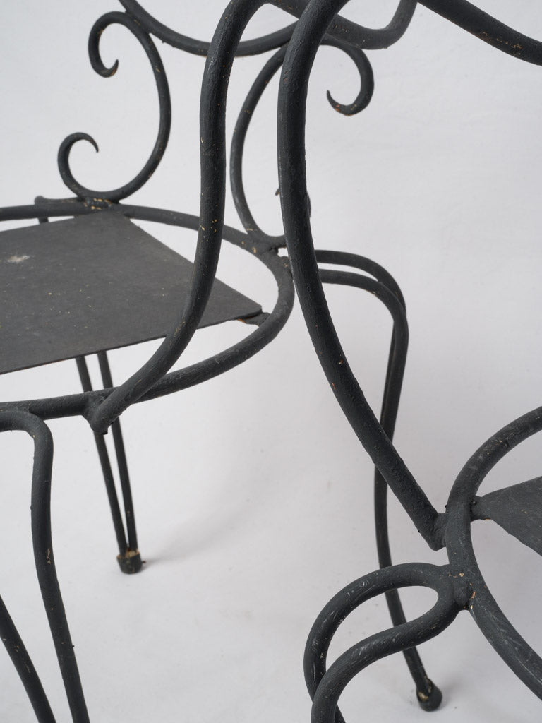 Delicate scrollwork wrought iron seating