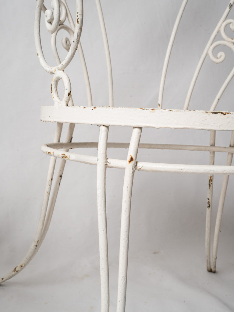 Off-white wrought iron armchairs