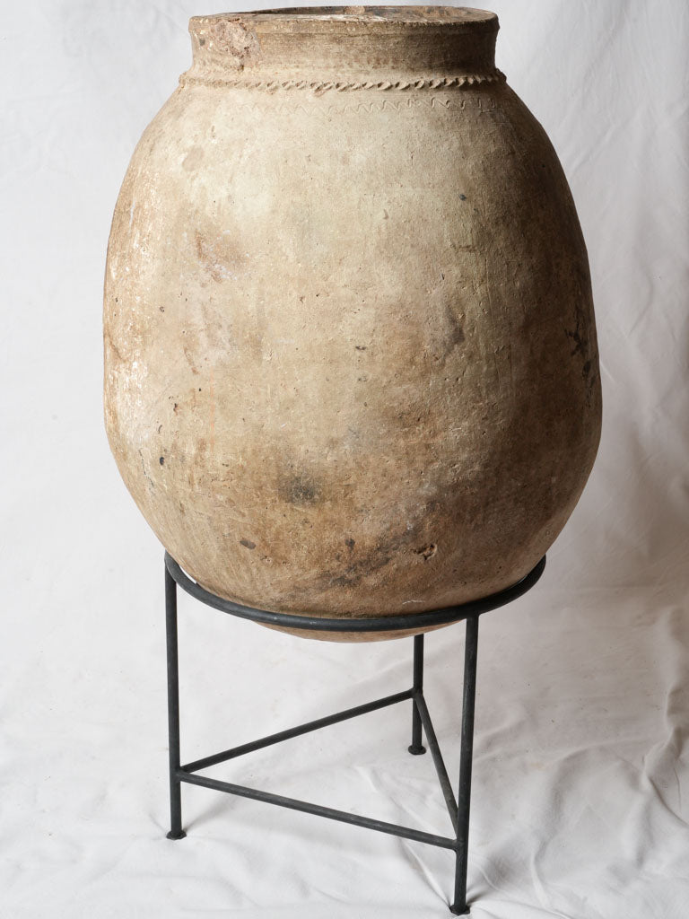 Aged clay jar on pedestal