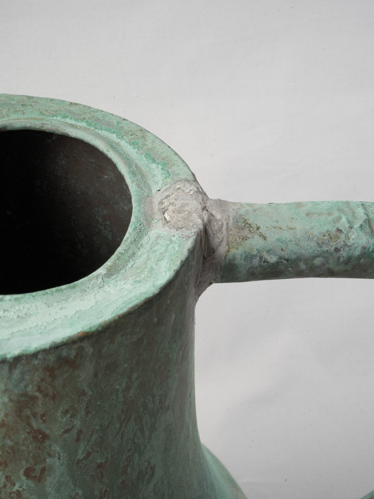 Mottled patina rustic watering vessel
