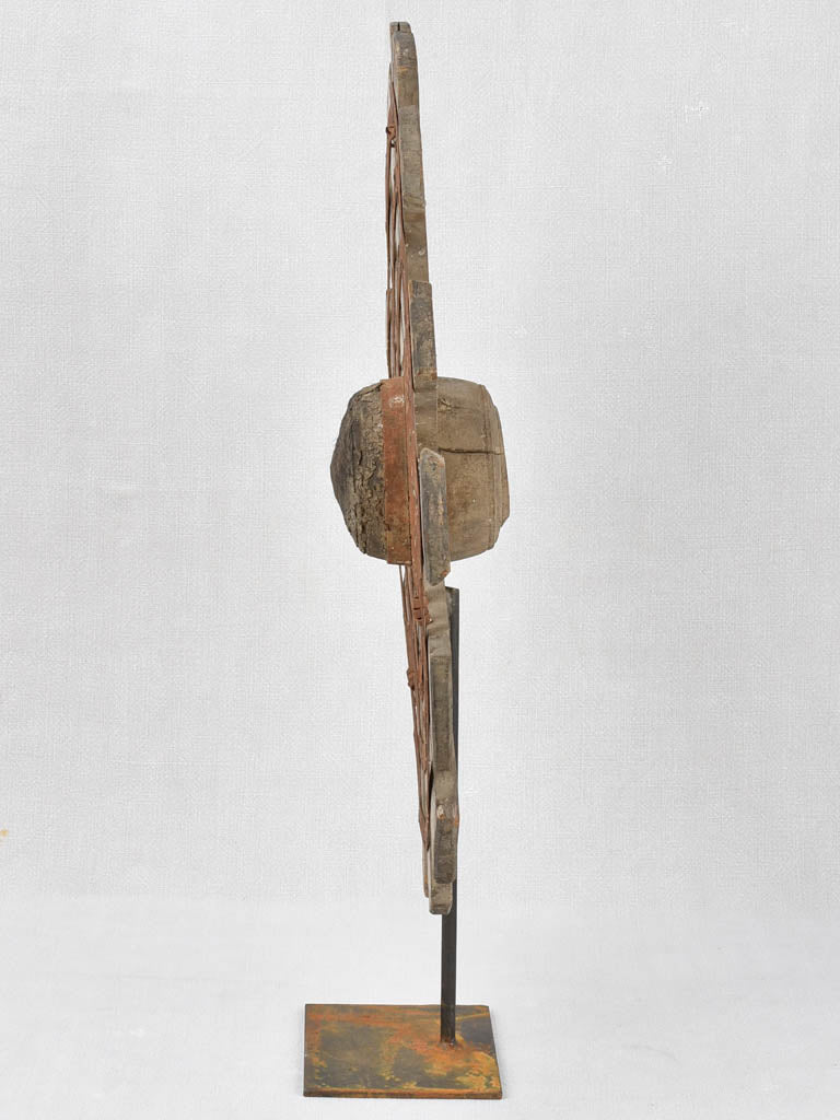 Sculptural wood sunburst on iron base