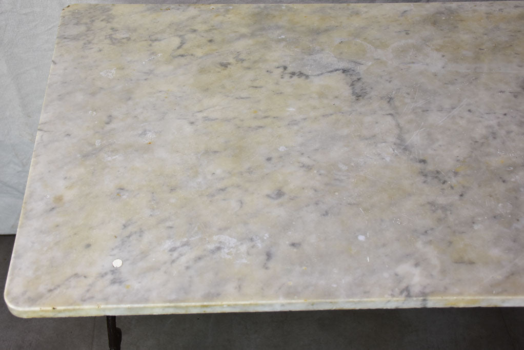 Late nineteenth century French marble presentation table with cast iron base 23¾" x 40½"