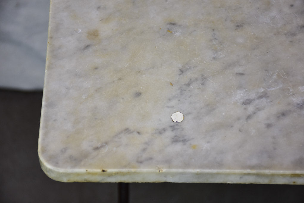 Late nineteenth century French marble presentation table with cast iron base 23¾" x 40½"
