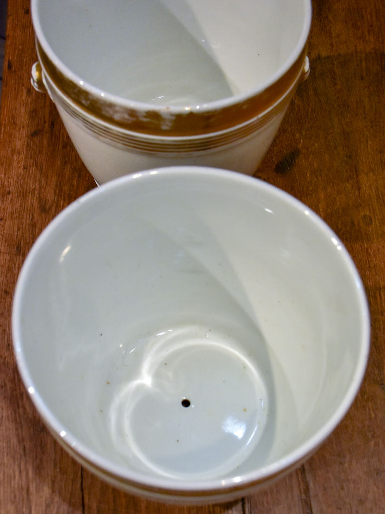 Pair of antique French porcelain pot stands with gold lion's heads