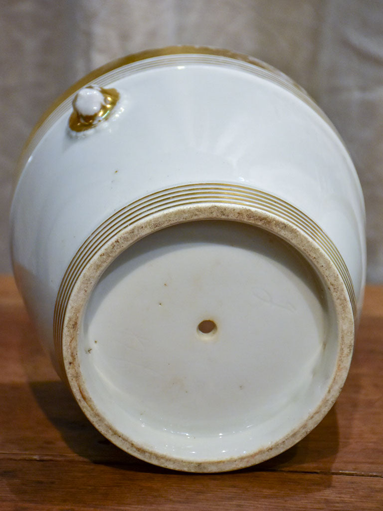 Pair of antique French porcelain pot stands with gold lion's heads