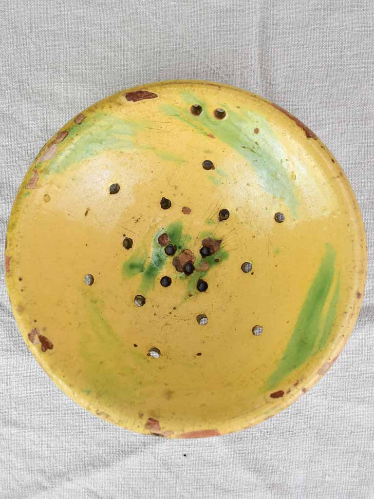 Antique French fruit strainer with yellow and green glaze 9"