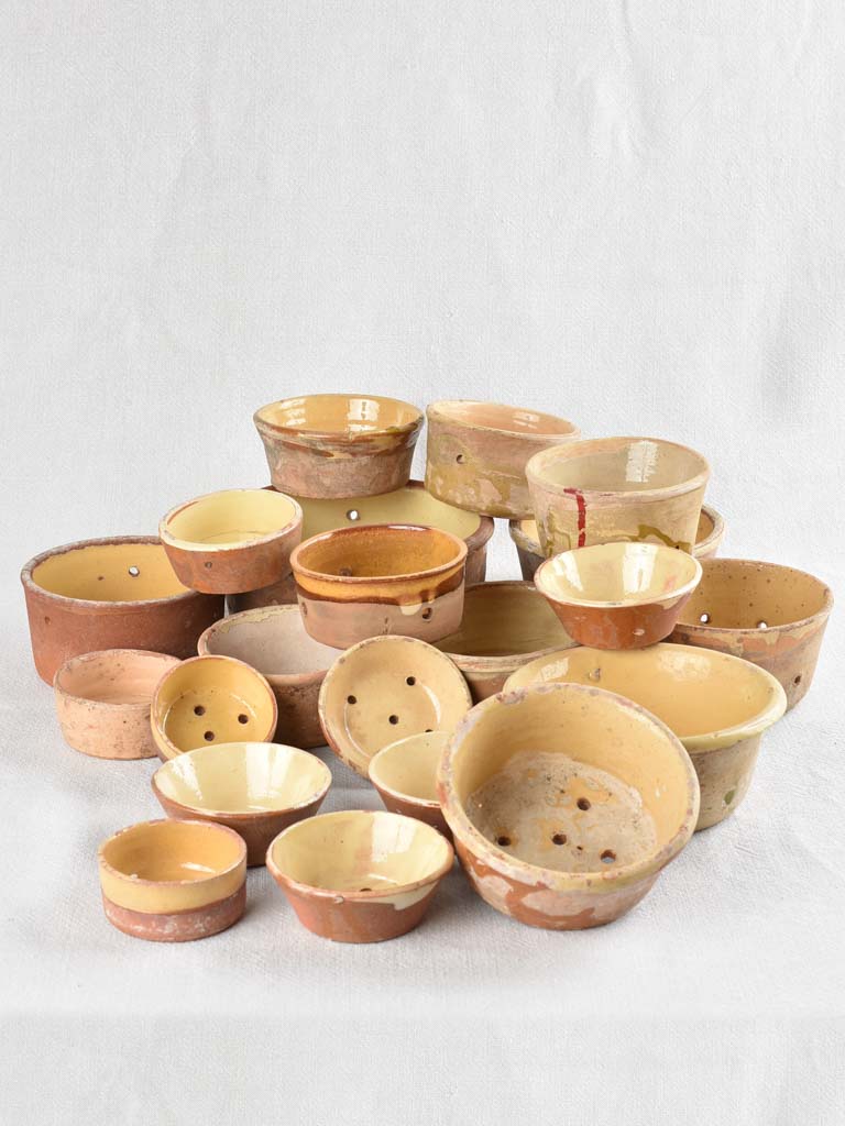 Collection of 21 terracotta cheese strainers 'faisselles'