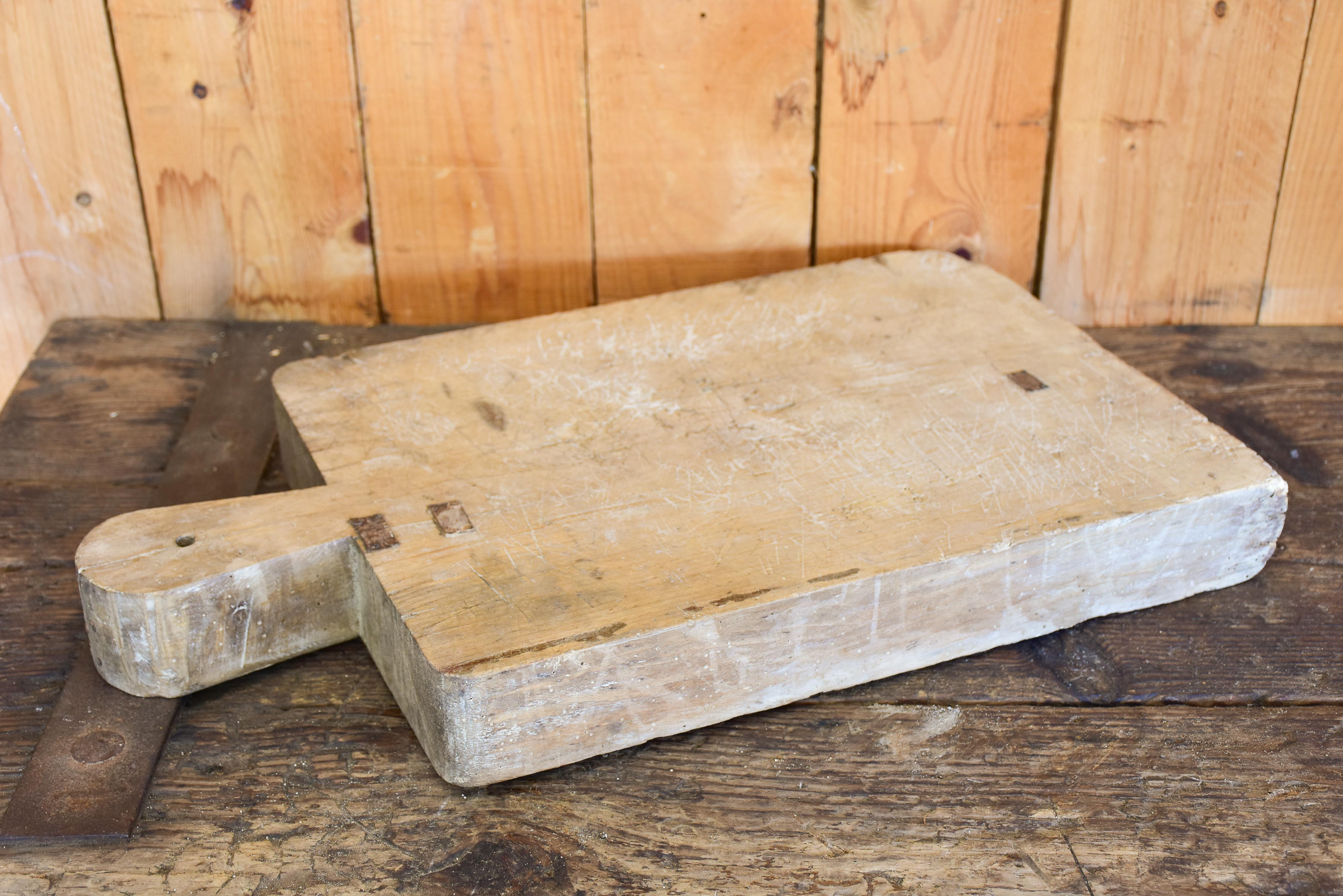 Large French cutting board with repairs and tapered handle